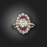 A ruby and diamond cluster ring, centred with an old circular-cut diamond within oval surround of