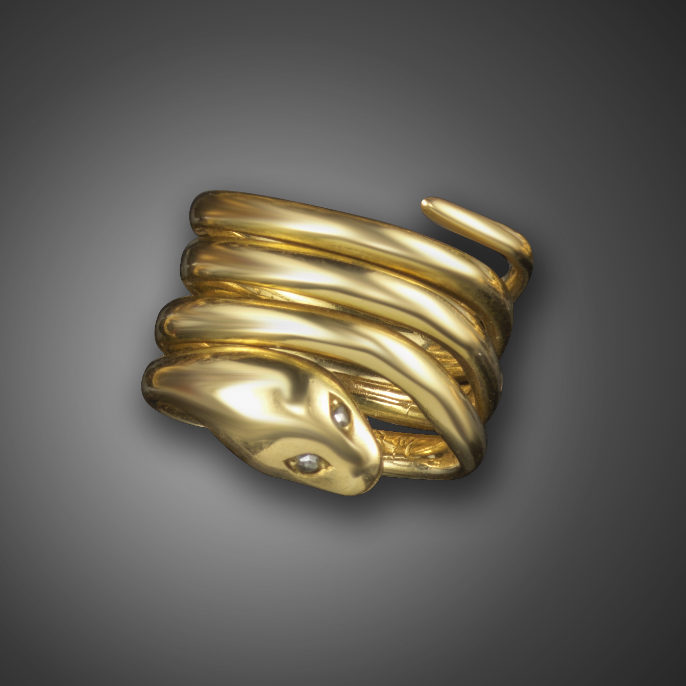 A Victorian gold coiled snake ring, with rose-cut diamond eyes, stamped 18 and maker's mark GB,