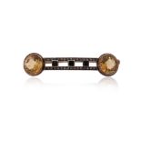 A citrine, onyx and diamond-set bar brooch, set with two circular-cut citrines with square-shaped