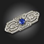 An Art Deco colour-change sapphire and diamond brooch, the oval-shaped sapphire weighs approximately