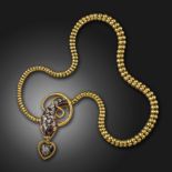 A Victorian garnet and diamond snake necklace, the stylised serpent's head formed from a garnet