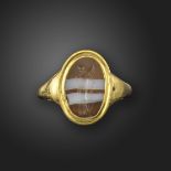 An Italic-Roman banded agate intaglio depicting Victory (Nike), c.2nd century BC, 1.4cm high, in a