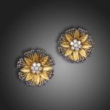 A pair of gem-set gold earrings by Van Cleef & Arpels, of flowerhead design, centred with a