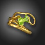 A gem-set gold ring, designed as a snake eating a frog, with green enamel decoration, ruby and