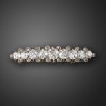A 19th century diamond hairslide / brooch, set with graduated old cushion-shaped diamonds and rose-
