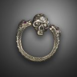 A diamond-set memento mori ring, the double headed serpents suspend a spinning skull between them,