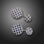 A pair of sapphire and diamond chequerboard circular cufflinks, alternately-set with calibre-cut