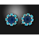 A pair of turquoise diamond and lapis lazuli earrings by Cartier, the stylised flowerheads set in