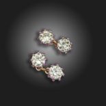 A pair of diamond and ruby-set cufflinks, the four transitional circular-cut diamonds weigh