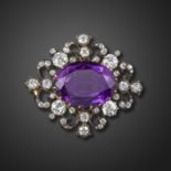 A Victorian amethyst and diamond-set brooch pendant, centred with an oval-shaped amethyst, with