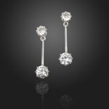 A pair of diamond drop earrings, each circular-cut diamond suspends a larger circular-cut diamond on