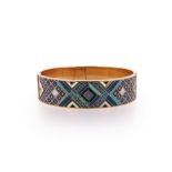 A gem-set gold bangle, of mosaic design, inlaid with hardstone panels, mother-of-pearl and paste