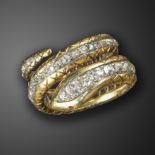 A diamond-set snake ring, the coiled snake body set with a line of graduated old cushion-shaped