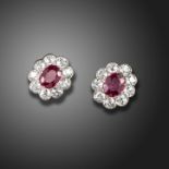 A pair of ruby and diamond cluster earrings, the oval-shaped rubies are set within a surround of old