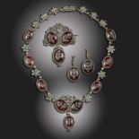 A late 18th century cut-steel and paste parure, comprising a necklace, brooch and earrings, each set