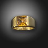 A citrine-set gold Tank ring by Cartier, the square-shaped cabochon citrine is channel-set in