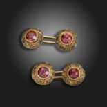 A pair of garnet-set yellow and white gold cufflinks, c.1900, each dome-shaped link centred with a