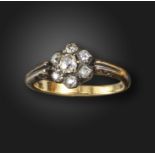 A Victorian diamond cluster ring, set with graduated old cushion-shaped diamonds in silver and