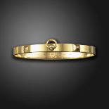 A 'Collier de Chien' gold bangle by Hermes, designed as a dog collar in gold, signed Hermes,