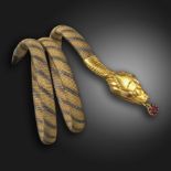 A late 19th century gold serpent bangle, the realistically formed snake with ruby eyes and a ruby