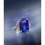 A cushion-shaped colour change sapphire and diamond ring, set with graduated circular and baguette-