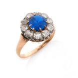 A French blue stone and diamond cluster ring, the synthetic blue stone set within a surround of