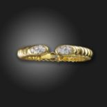 A diamond set gold bangle believed to be by Wander, the terminals set with clusters of gradauted