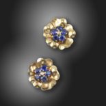 A pair of gem-set gold flower earrings by Boucheron, set with circular-cut sapphires and an old