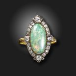 An opal and diamond cluster ring, the oval opal cabochon set within a surround of old cushion-shaped