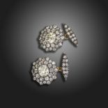 A pair of diamond cluster cufflinks, each link centred with an old circular-cut diamond within two