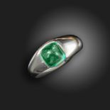 An emerald-set gypsy ring, the emerald cabochon is set in platinum, size K Accompanied by report