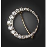 A Victorian diamond-set closed crescent brooch, set with graduated old circular-cut diamonds in