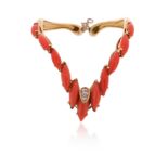 λ A coral and diamond-set bangle by David Morris, of chevron design, set with navette-shaped coral