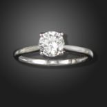 A diamond solitaire ring, the round brilliant-cut diamond weighs 0.98cts, claw-set in white gold,