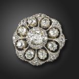 A Victorian diamond-set target brooch, centred with a square cushion-shaped diamond weighing