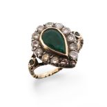 An emerald and diamond cluster ring, the pear-shaped emerald set within a surround of diamonds, in