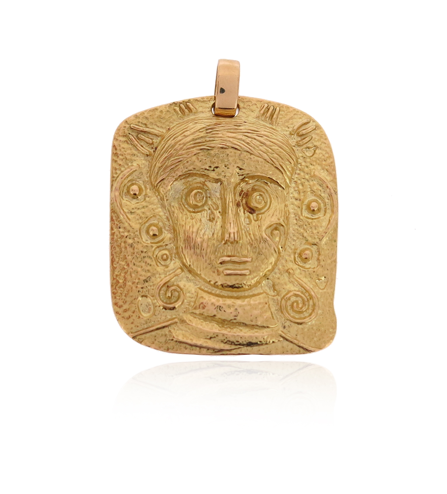 A gold medallion pendant, the square pendant depicting the abstract portrait of a woman in