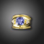 A colour change sapphire and diamond ring, the octagonal sapphire weighs 6.48cts and is flanked with