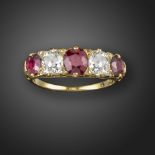 A late 19th century ruby and diamond half-hoop ring, set with graduated cushion-cut rubies and