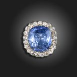 A sapphire and diamond cluster ring, the cushion-shaped sapphire weighs approximately 38.00cts,