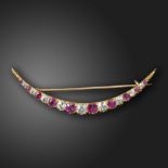 A Victorian gem-set crescent brooch, the open crescent set with gradauted old circular-cut