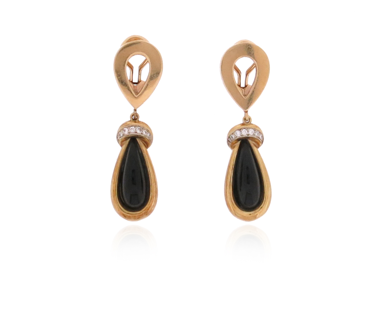 A pair of onyx and diamond drop earrings, set in yellow gold, clip fittings, 4.7cm high