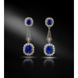 A pair of Edwardian sapphire and diamond drop earrings, the upper cluster sections set with