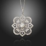 An Edwardian diamond pendant, of quatrefoil design, centred with an old circular-cut diamond