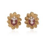 A pair of ruby and diamond clip earrings, of flowerhead design, centred with a cluster of circular-