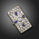 A sapphire and diamond rectangular plaque ring, pierced and decorated with pear-shaped sapphires and