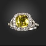 An Edwardian chrysoberyl and diamond cluster ring, centred with a cushion-shaped chrysoberyl