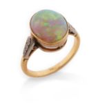 An opal and diamond ring, the opal millegrain set with old circular-cut diamonds to the shoulders in