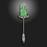 An Art Deco gem-set white gold stick pin by Ghiso, the seated green glass Buddha set with old