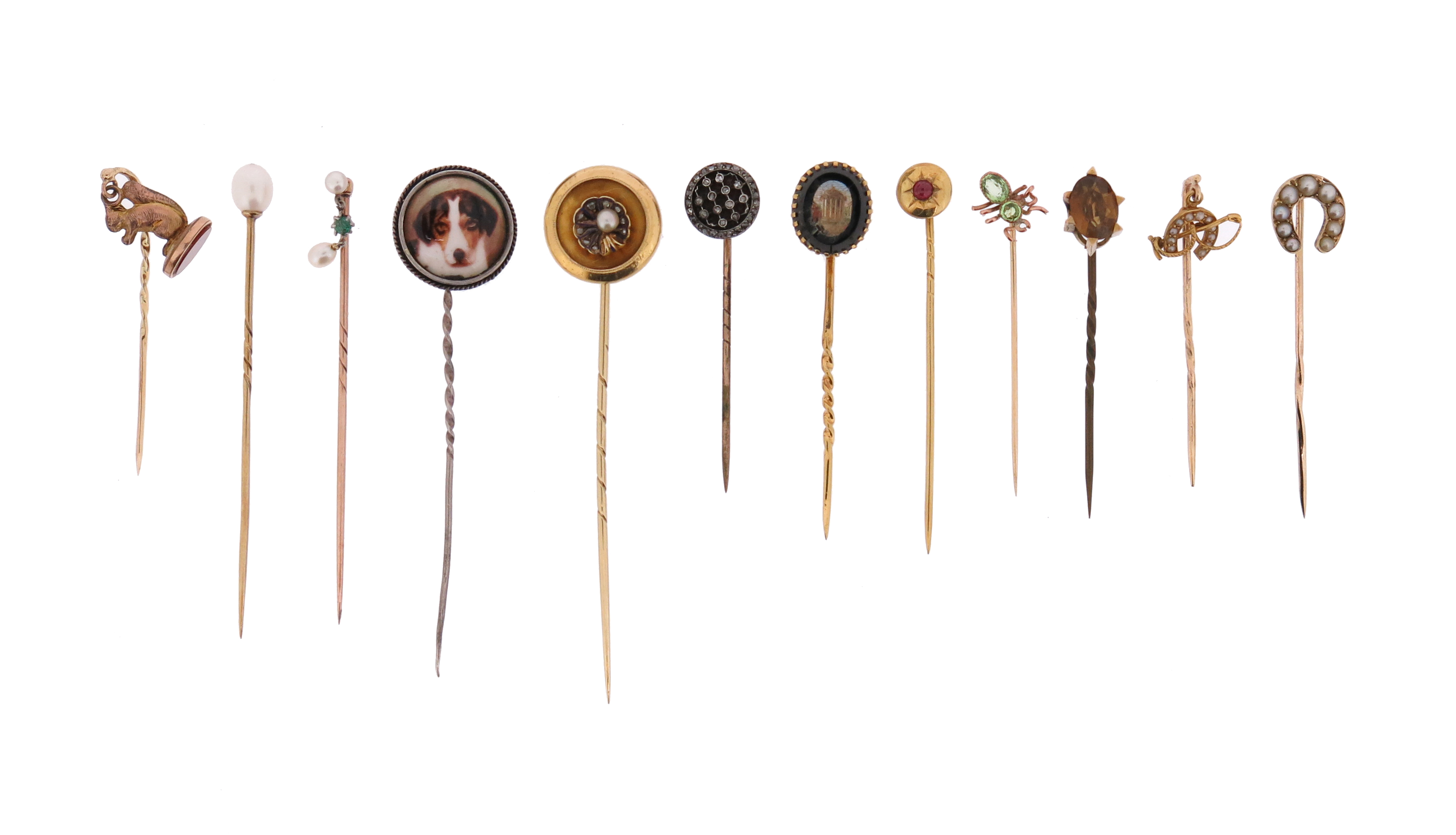 A cased set of twelve stick pins, including a rose-cut diamond-set circular pin in silver on gold, a